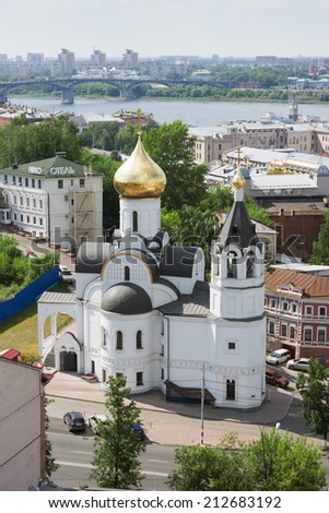 RUSSIA, NIZHNY NOVGOROD - AUG 06, 2014: View of the Church of Our Lady of Kazan to the Kremlin wall. This church was destroyed during the Soviet era and the newly restored