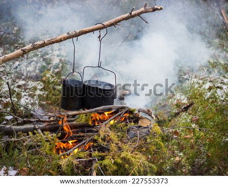 Cooking on a fire in field conditions, October