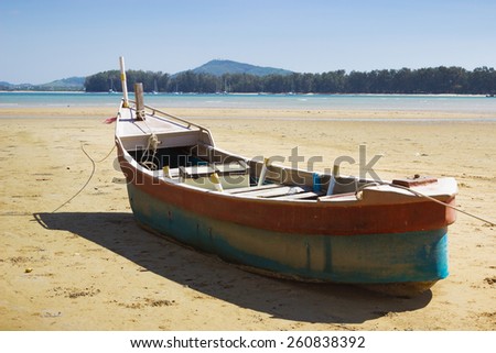 Fishing boat on land in the area of sea tide