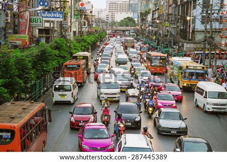 BANGKOK, THAILAND - FEB 19, 2015: Everyday street scene with transport and the with unidentified people. Bangkok is one of the most important economic and transport centres in South-East Asia