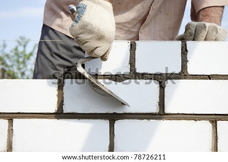 Construction of the wall of white brick