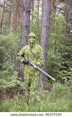 The shooter in camouflage with an old gun