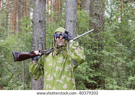 The shooter in camouflage with an old gun