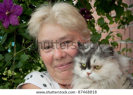 A housewife and her pet cat in the garden
