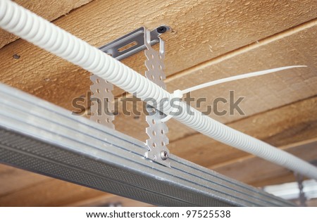 Electrical wiring is laid in a suspended ceiling