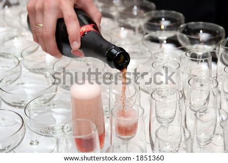 pouring red wine in cup