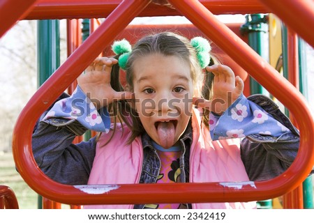 a little child sticking out tongue, cheeky