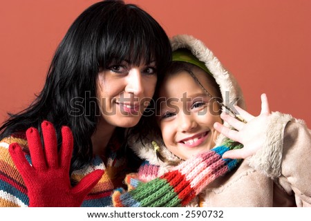 mother and daughter waving hands