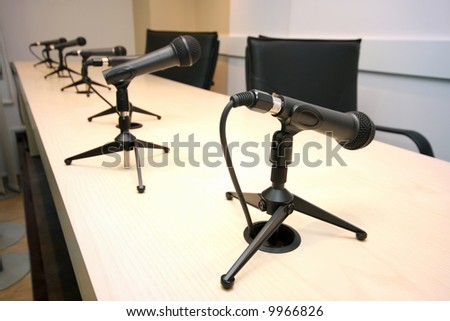 Press Conference, conference room with microphones in row