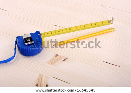 closeup shot of wooden plank and measuring tape