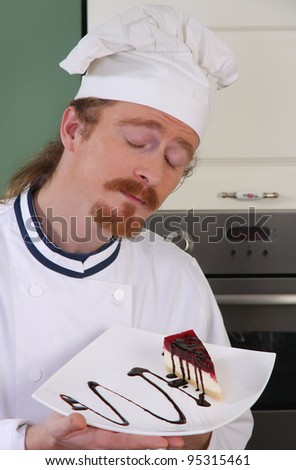 Funny young chef smelling a piece of cake with chocolate sauce
