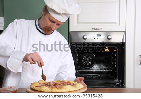 Young chef prepared italian pizza in kitchen