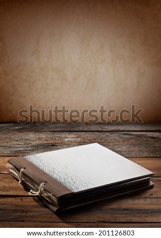 old diary book over wooden background