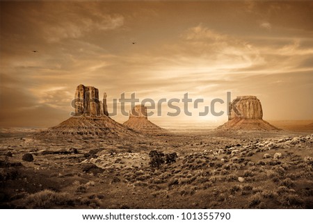 A sepia toned photograph of a sunset in the Monument Valley region of the Colorado Plateau that spans the northern border of Arizona and southern border of Utah.
