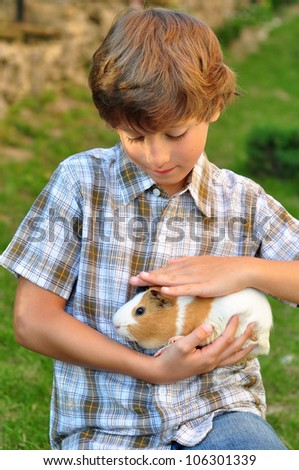 Boy holding a guinea pig
