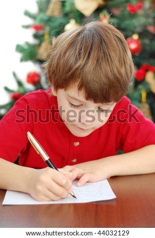 6 year old boy writing a letter to Santa.Close Up.