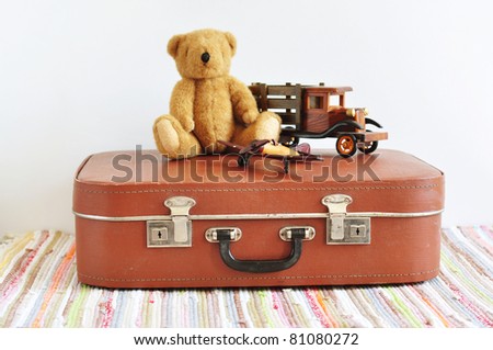 Vintage toys on the old suitcase