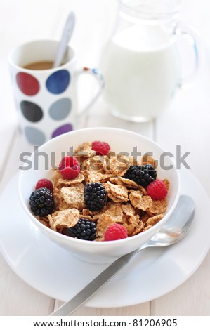 Bowl of cereal with berries and milk for breakfast