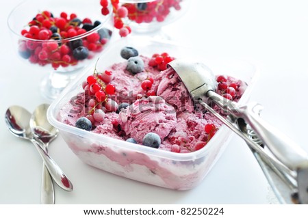 Berry ice cream in a plastic container