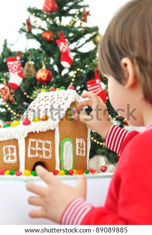 Little boy decorating the Gingerbread House