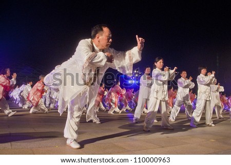 FOSHAN CITY, CHINA - AUGUST 8: More than 300 elderly perform Tai Chi in Foshan square during government held National Sports Day activies, advocating the public sports, on August 8, 2012 in Foshan, China