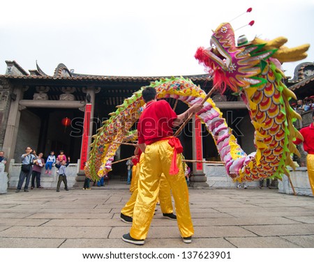 FOSHAN CITY-MARCH 22:In 2013 the dragon dance competition held in Foshan ancient house, pictures of the Nanhai dragon dance team in the show March 22,2013 in Foshan,China