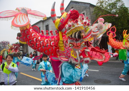 FOSHAN CITY - APRIL 12: To celebrate the birthday of the temple of God, Taoists held the China traditional culture parade, dance team performances in fish - Dragon April 12 , 2013 in Foshan, China