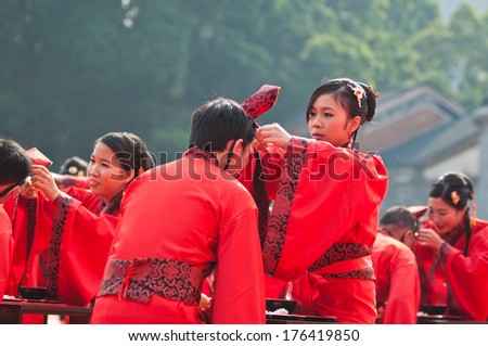FOSHAN, CHINA - JUNE 5:The women's Federation held in the ancient temples of traditional collective wedding ceremony, 30 couples participated, including parade and celebration Jun 5, 2014 in Foshan, China
