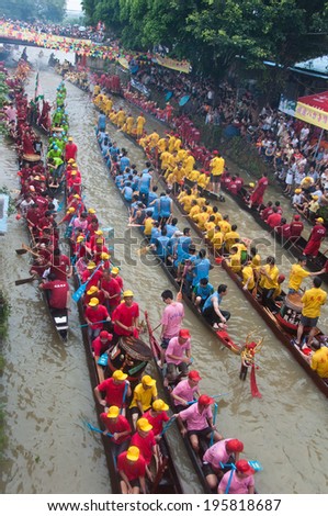 FOSHAN CITY, CHINA - JUNE 26: Foshan City hold dragon boat festival, many 50 Dragon Boat gathered in Foshan River, lively and extraordinary June 26, 2012 in Foshan City, China