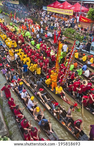 FOSHAN CITY, CHINA - JUNE 26: Foshan City hold dragon boat festival, many 50 Dragon Boat gathered in Foshan River, lively and extraordinary June 26, 2012 in Foshan City, China