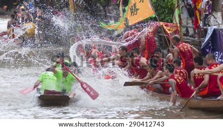 FOSHAN-June 23:The Dragon Boat Festival dragon boat race, the athletes on the river water play each other, having a great time June 23, 2015 in Foshan, China