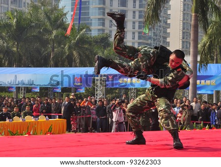 FOSHAN CITY, CHINA - JANUARY 10: Unidentified armed policemen in action display Chinese martial arts on stage during Police Public Open Day at the park January 10, 2012 in Foshan, China