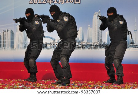 FOSHAN CITY, CHINA - JANUARY 10: Unidentified special policemen display use of firearms on stage during Police Public Open Day at the park January 10, 2012 in Foshan, China