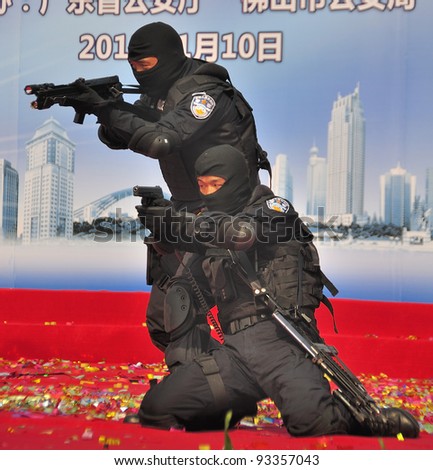 FOSHAN CITY, CHINA - JANUARY 10: Unidentified special policemen display use of firearms on stage during Police Public Open Day at the park January 10, 2012 in Foshan, China