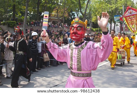 FOSHAN, MARCH 23: Chinese People Wearing Masks In The Street Parade, In Orderto Celebrate The Birthday Of The Temple Of God, Foshan Temple Organized Apeople\'s Parade March 23, 2012 in Foshan, China