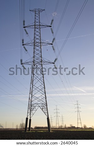 high voltage power tower and electrical lines coming from the power station