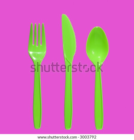 vibrant green plastic fork, knife and spoon (pink background)