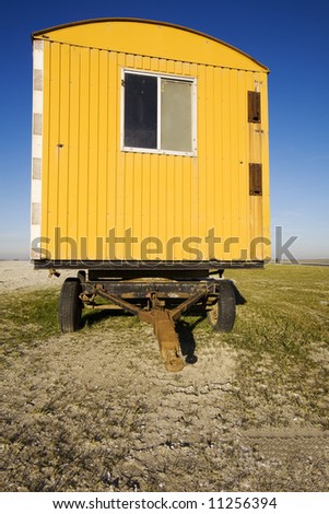 yellow shed on a construction yard (blue sky)