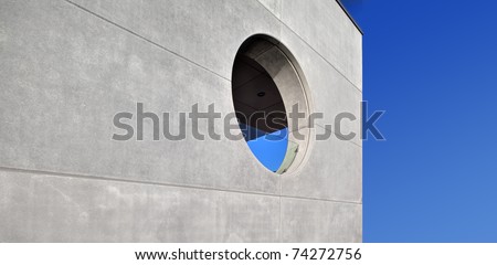 concrete building, round window, blue sky