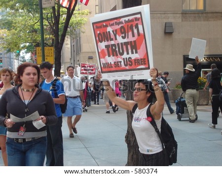 An angry protester shouts to passersby to open their eyes to the truth about 9/11.