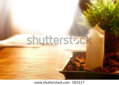 Candels on a wood table, in front of window sunshine
