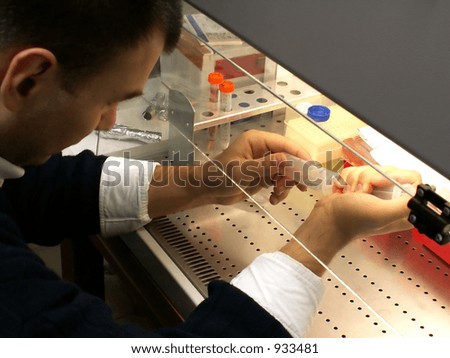 scientist working in sterile conditions in laboratory