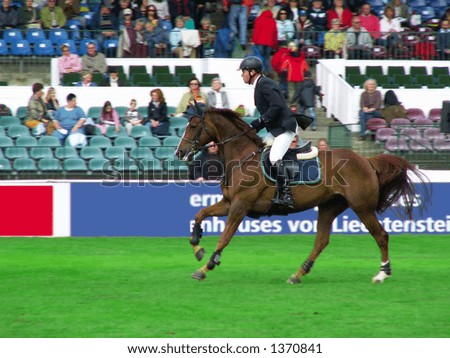 Jockey man riding a thoroughbred horse at a derby competition