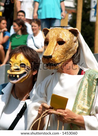 Two women wearing animal masks at street carnival