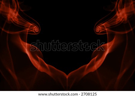 Colored red smoke trail in shape of heart on black background