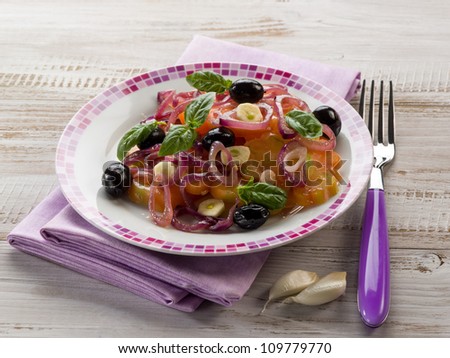 salad with ox heart tomatoes, onions olives and garlic