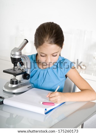 little girl  study with microscope