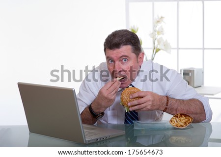 manager eating unhealthy food at work place