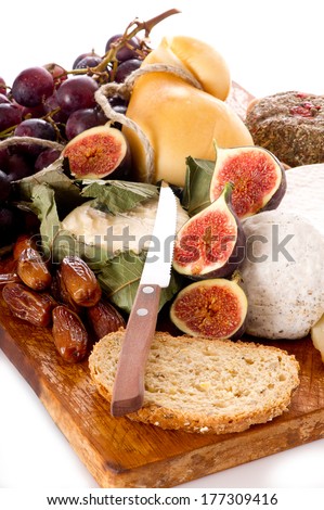 cheeseboard  with an assortment of cheeses  and fruits