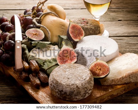 Cheeseboard With An Assortment Of Cheeses And Fruits